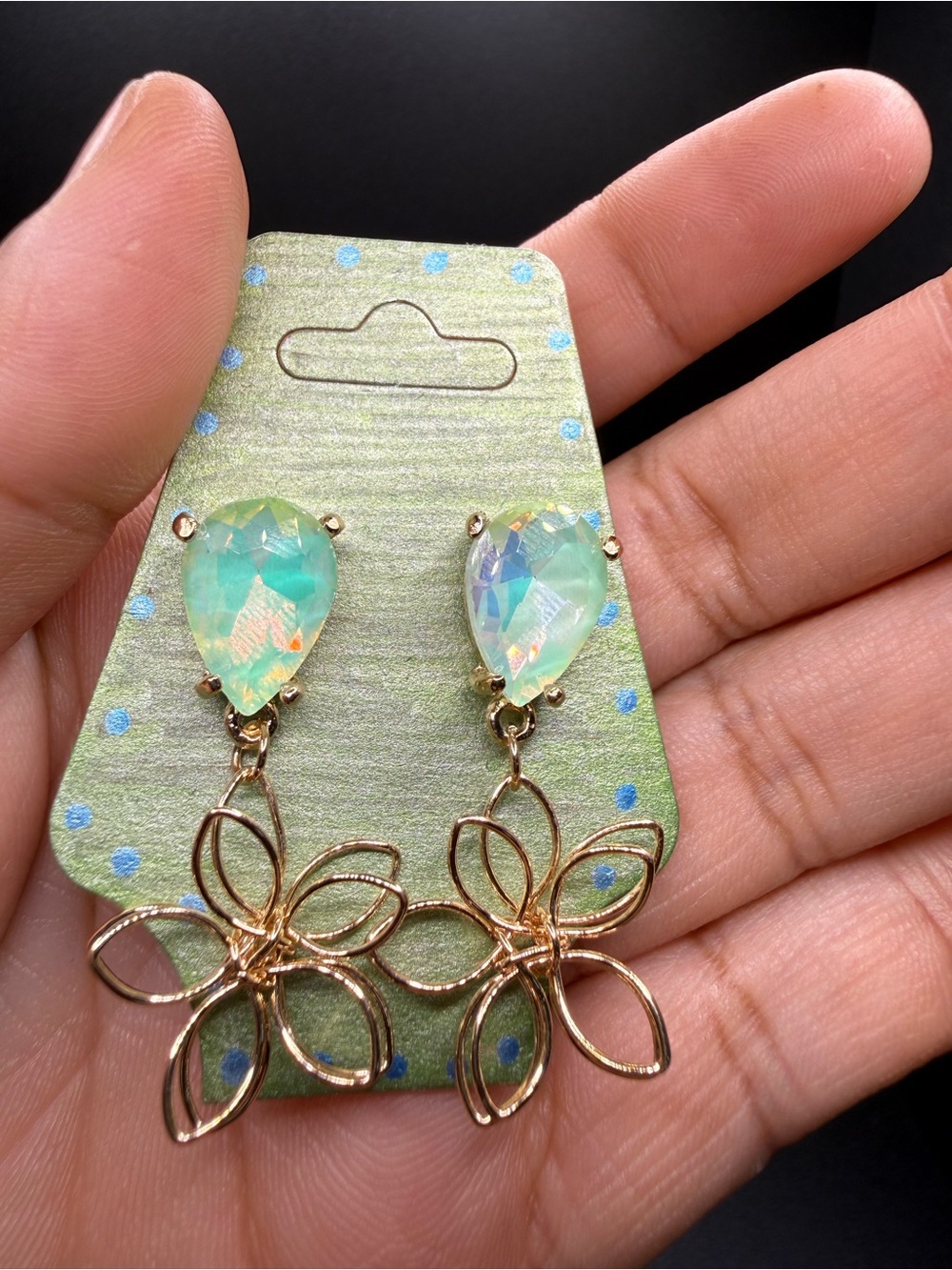 Teardrop iridescent minty crystal earrings with gold wire flower dangle.